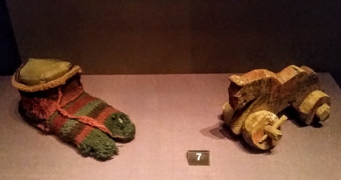 Roman Egypt: child's stripy wooden sock (3rd -4th c. AD) and a wooden toy horse (1st-3rd c. AD). The British Museum. Photo by Medievalists.net
