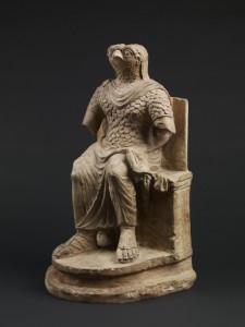 Seated figure of the ancient Egyptian god Horus, wearing Roman military costume, limestone, Egypt, 1st–2nd century AD © The Trustees of the British Museum.